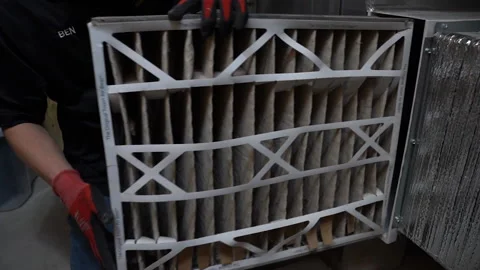 Removal of a dirty central air conditioning filter Stock Footage 195458083
