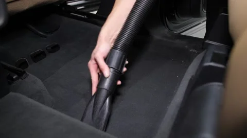 Removal of garbage on carpets in the car interior using a vacuum cleaner. Video stock 247300634