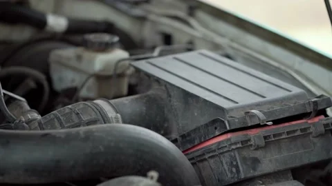 Removal of the old air filter. Air Intake Systems. Old and new car filter. Stock Footage 208391967