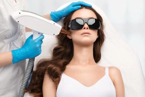 Removal of permanent makeup on the eyebrows of a woman.Carbon face peeling .. Stock Photos