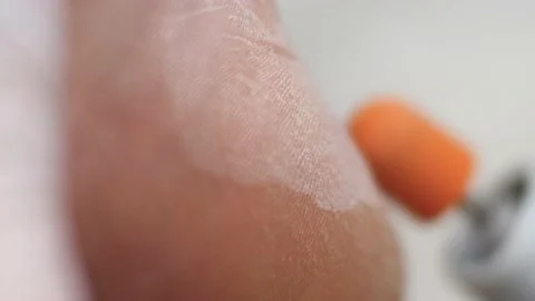 Removal of rough keratinized layer from the heel skin using the grinding tool Stock Footage 239640069