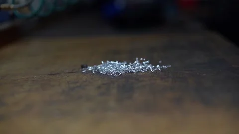 Remove the aluminum spark with compressed air from a Workbench Stock Footage 203855824