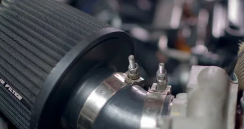 Remove the car air filter to clean it.Unscrew the nuts holding the air filter. Stock Footage 307892924