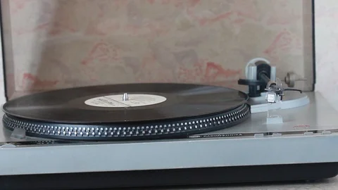 Remove the disc from support plate of the vinyl player Stock Footage 88595093