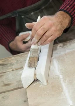 Remove dust with a brush of a piece of marble Stock Photos