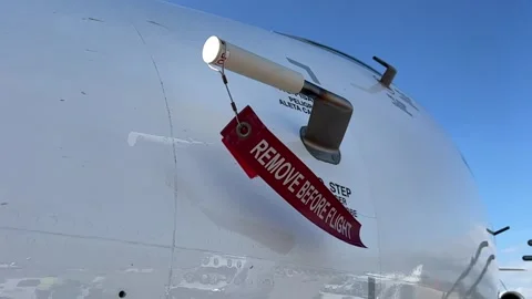 Remove before flight strap pitot cover on a modern jet from Stock Footage 252165802