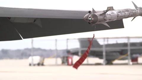 Remove before flight tag attached to ordnance blowing in wind Stock Footage 102833732