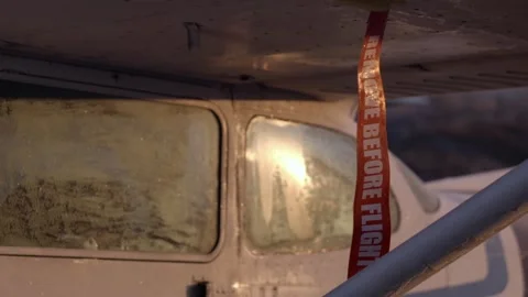 Remove Before Flight Tag on Iced-Up Airplane Exterior - Golden Hour Stock Footage 307379025