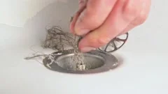 remove hair from the shower drain, Stock Video