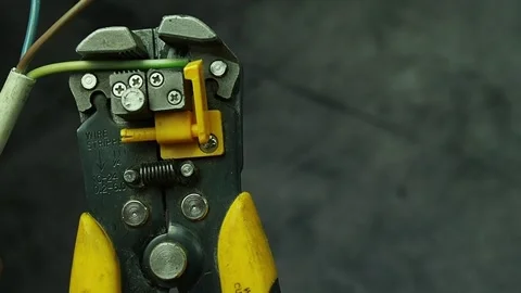 Remove insulation from wires with a crimper close-up Stock Footage 193743761