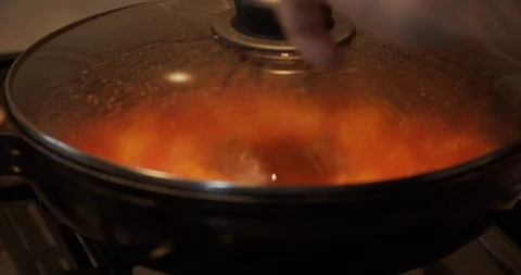 Remove the lid from the pot With Condensation Stock Footage 129059810