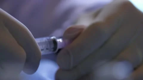 Remove lid from syringe and draw from vial Stock Footage 20447561