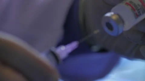 Remove lid from syringe and draw from vial Stock Footage 20447647