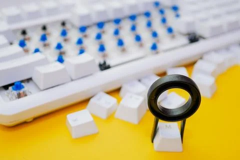Remove mechanical keyboard keycap with tool on yellow background Stock Photos