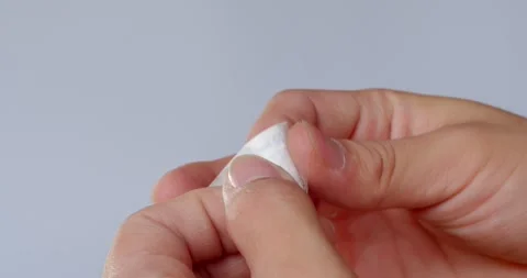 Remove the needle from package.Hands in medical gloves remove the syringe. Stock Footage 263574575