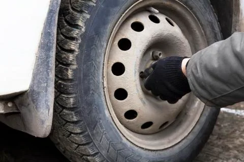 Remove the nut the wheel of a car Stock Photos