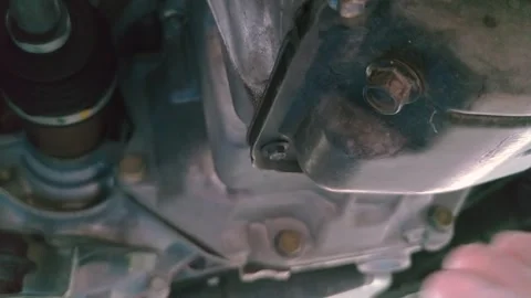 Remove old oil from the drain bolt to change the oil Zoom-in Stock Footage 297125155