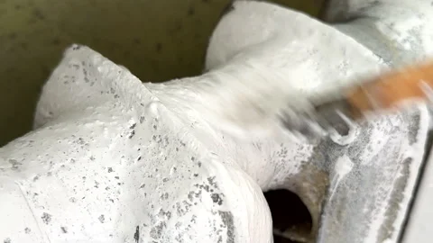 Remove old paint from Radiator. Sanding rusty radiator for painting. Stock Footage 274343719