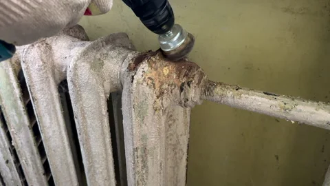 Remove old paint from Radiator. Sanding rusty radiator for painting. Stock Footage 276737570