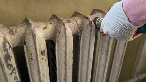 Remove old paint from Radiator. Sanding rusty radiator for painting. Stock Footage 276738158