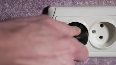 Remove the plug from the electrical appliance from the socket. Slow motion Stock Footage 244662563