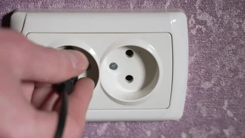 Remove the plug from the electrical appliance from the socket. Slow motion Stock Footage 244662740
