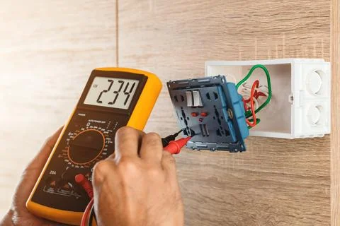 Remove the power electric plug socket from the outlet box on the wooden wal.. Stock Photos