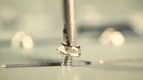 Remove a screw with the magnetic tip of a screwdriver Stock Footage 78046722