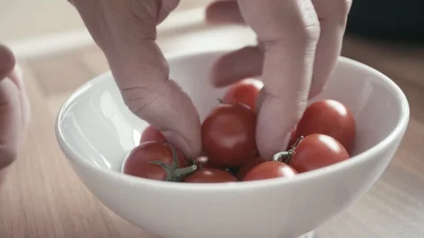 Remove small tomatoes from bowl Stock Footage 95490561