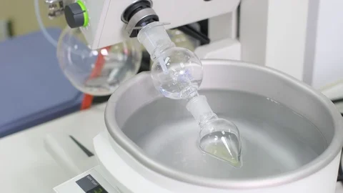 Remove solvent out from the sample by using a rotary evaporation machine Stock Footage 129829249