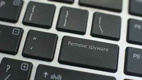 Remove spyware button on computer keyboard, female hand fingers press key 動画素材 97826324