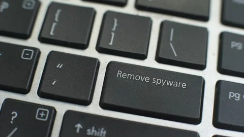 Remove spyware button on computer keyboard, female hand fingers press key 動画素材 97828584