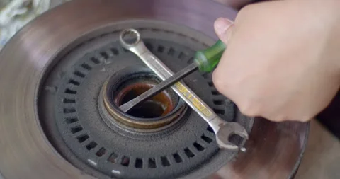 Remove the waterproof seal from the wheel hub.Take apart the parts for cleaning. Stock Footage 277414908