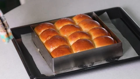 Removed side cover tray from the bread by using cloth. Homemade of fresh bread Stock Footage 128639693