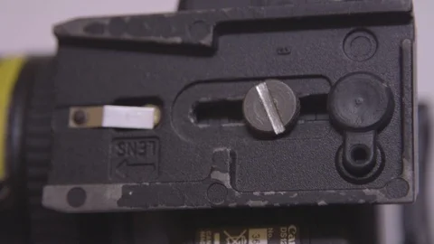 Removing 502 Tripod Base plate from DSLR using coin Stock Footage 123724692
