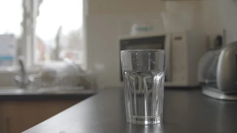 Removing and placing plastic straws into a glass Stock Footage 85826785