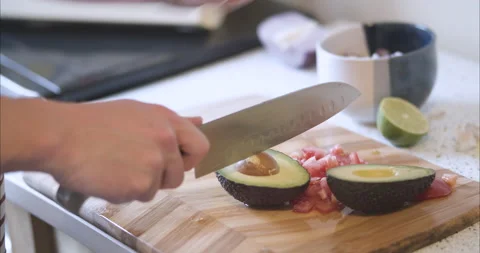 Removing avocado pit or pitting an avocado Stock Footage 155547891