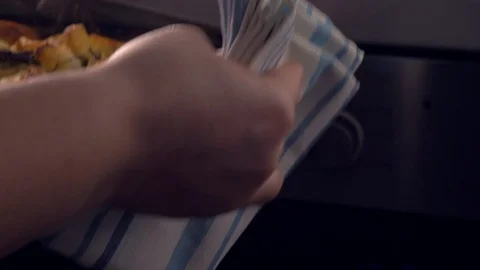 Removing baked potatoes from the oven Video stock 103528346