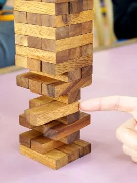 Removing blocks from a tower. Stock Photos