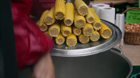 Removing boiled sweet corn cobs from hot water, street vendor, food Stock Footage 37124434