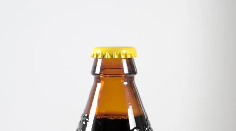 Removing bottle top from a brown colored bottle with an opener. Stock Footage 59760940