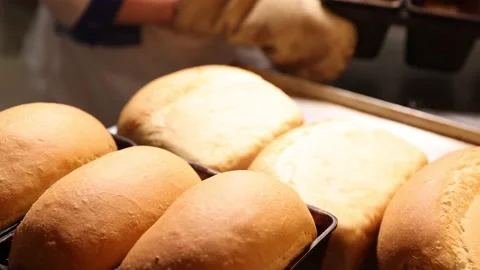 Removing bread from the mold. Bakery baking process in factory. Bakery activity Video stock 151178893