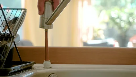 Removing broken kitchen faucet from sink, DIY plumbing repair process at home Vídeos de archivo 334040864