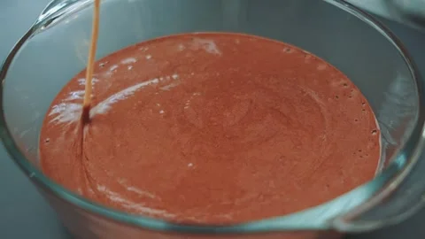 Removing bubbles from chocolate dough with a wooden skewer Stock Footage 252179528
