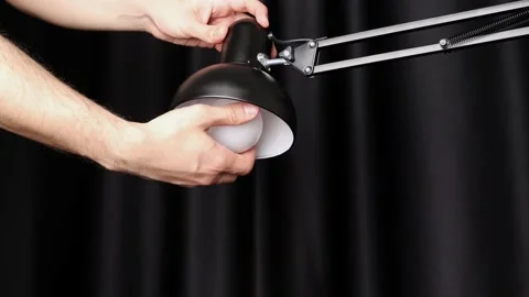 Removing the bulb from the desk lamp 스톡 동영상 184615083