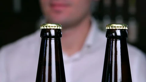 Removing the caps from bottles of beer closeup Stock Footage 58033559