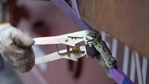 Removing cargo strap. Construction worker detaching rope Stock Footage 97203193