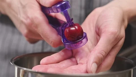 Removing the cherry pit. Process of making cherry jam. Stock Footage 153459197