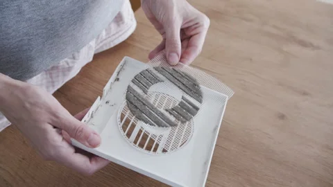 Removing Clogged Dust Mesh Filter from Air Vent Frame Above Table Stock Footage 341398272