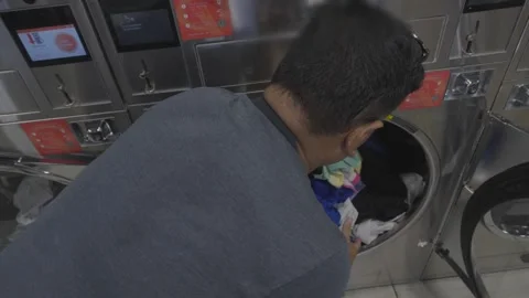 Removing clothes from the dryer Video stock 310280375